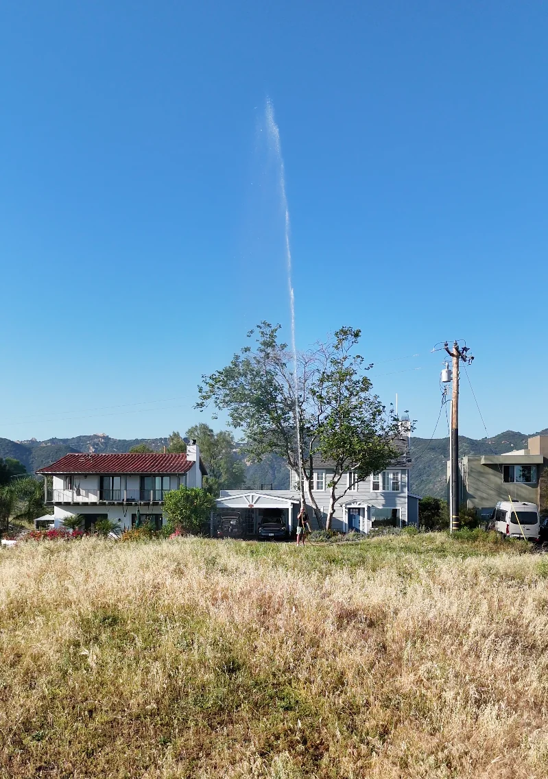 Hainy Hydrant spraying high-pressure water on a Malibu home